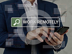 WORK REMOTELY text in search bar. Businessman looking for something at cellphone. Remote workÃÂ is aÃÂ workingÃÂ style that allows